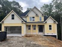 New construction two-story home with a two-car garage and classic architectural details at 221 Autumn Brook Dr, Canton, GA 30115