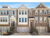 Charming townhomes feature brick exteriors, symmetrical windows, and attached garages for convenient parking at 826 Bexley Park Way, Mableton, GA 30126