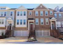 Charming townhome featuring a brick facade, attached garage, and a welcoming entryway at 826 Bexley Park Way, Mableton, GA 30126