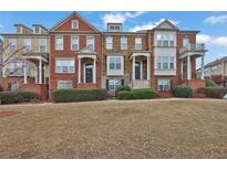 Charming townhomes featuring brick facades, manicured landscaping, and inviting front entrances at 4874 Seldon Se Way, Smyrna, GA 30080