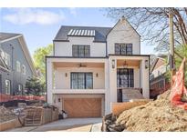 Striking two-story modern home with a covered porch, distinctive black-framed windows, and a convenient two-car garage at 555 Orme Ne Cir, Atlanta, GA 30306