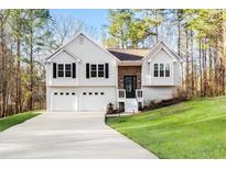Charming split-level home featuring a two-car garage and manicured lawn on a lush lot at 88 Summer Lake Pl, Dallas, GA 30157