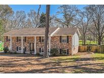 Charming brick home featuring classic shutters and a well-maintained yard at 3045 Riviera Nw Dr, Conyers, GA 30012