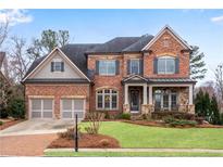 Elegant brick home with a well-manicured lawn and a two-car garage at 4850 Kentwood Dr, Marietta, GA 30068