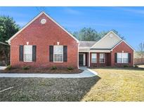 Charming single-story brick home featuring a well-maintained lawn and inviting curb appeal at 524 Plantation Creek Dr, Loganville, GA 30052
