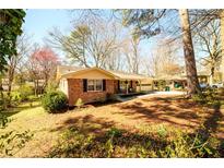 Charming brick home with an attached garage and a well-maintained front yard at 2899 Pangborn Rd, Decatur, GA 30033