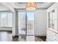Bright living room with hardwood floors, balcony access, and city views at 3445 Stratford Ne Rd # 502, Atlanta, GA 30326
