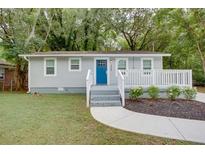 Charming single-story home featuring a blue front door, white trim, and manicured landscaping at 2598 Elliott Nw St, Atlanta, GA 30318
