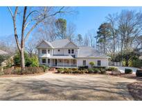 Charming two-story home with a covered front porch and a well-manicured front yard at 325 Wynland Trce, Sandy Springs, GA 30350