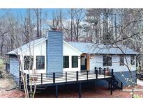 Charming single-Gathering home with a spacious deck and modern design nestled in a wooded neighborhood at 137 Creekview Dr, Woodstock, GA 30188