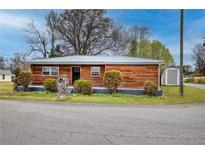 Charming single-story home with wood siding, metal roof, and neatly trimmed landscaping at 429 Old Tennessee Ne Hwy, White, GA 30184