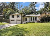 Charming two-story home with a well-manicured lawn and attached two-car garage at 5498 Stoneybrook Se Ct, Mableton, GA 30126