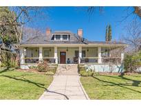Charming two-story home with a inviting front porch, manicured lawn, and mature trees at 1118 Glenwood Se Ave, Atlanta, GA 30316