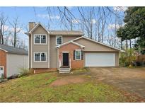 Charming two-story home with brick accents, attached garage, and well-maintained lawn in a peaceful neighborhood at 144 Grayland Hills Ct, Lawrenceville, GA 30046