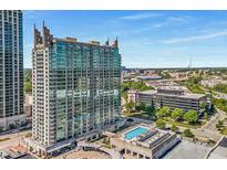 Stunning high-rise building with glass windows and a rooftop swimming pool overlooking the cityscape under clear blue skies at 361 17Th St # 1516, Atlanta, GA 30363