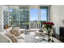 Bright living room featuring comfortable seating and a large window with an amazing city view at 1080 Peachtree Ne St # 2309, Atlanta, GA 30309