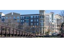 A multi-story apartment building showing modern architecture and streetscape, with a pedestrian bridge in the foreground at 390 17Th Nw St # 2025, Atlanta, GA 30363