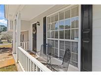 Inviting front porch with seating, offering a cozy outdoor space at 951 Orchard Mill Ln, Lawrenceville, GA 30043