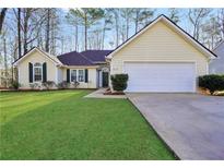 Charming single-story home features a well-maintained lawn, a two-car garage, and classic curb appeal at 170 Fairview Chase Rd, Covington, GA 30016