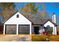 Charming home featuring a two-car garage, black trim, and a freshly landscaped yard at 3819 Landgraf Cv, Decatur, GA 30034