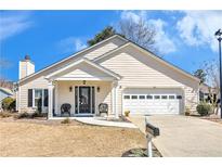 Charming single-Gathering home features a well-maintained front yard and inviting entrance with covered porch at 6 Alicia Ct, Marietta, GA 30062