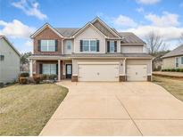 Charming two-story home with a three-car garage and well-maintained lawn at 9109 Alden Dr, Locust Grove, GA 30248