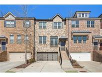 Charming brick townhomes with well-maintained landscaping and attached garages at 109 Bridlington St, Sugar Hill, GA 30518