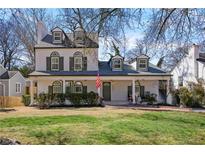 Charming two-story home with a welcoming front porch and meticulously landscaped yard at 2083 Fairhaven Ne Cir, Atlanta, GA 30305