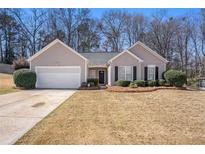 Charming single-story home with a well-manicured lawn and an attached two-car garage at 441 Concord Cir, Mcdonough, GA 30253