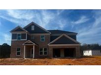 Two-story brick home featuring a two-car garage and covered front porch under a clear sky at 3191 Morris Hills Dr, Dacula, GA 30019