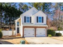 Charming two-story home featuring a brick-accented two-car garage and well-maintained landscaping at 503 Stanford Pl, Woodstock, GA 30188