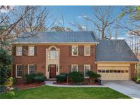 Charming two-story brick home with well-manicured lawn and attached two-car garage at 1061 Steeple Run, Lawrenceville, GA 30043