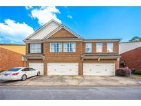 Charming brick townhouse with attached garages and well-maintained landscaping at 805 Pleasant Hill Rd # 222, Lilburn, GA 30047