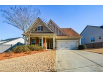 Charming single-Gathering home with a well-maintained lawn and attached two-car garage at 422 Windy Ridge Way, Canton, GA 30114