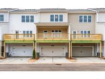 Exterior rear view of townhomes with garages and decks on the second level at 4822 Floydwood Ln, Mableton, GA 30126