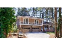 Charming home featuring a two-car garage and a second-story balcony for enjoying outdoor views at 1618 Cheryl Leigh Dr, Riverdale, GA 30296