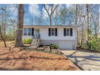 Charming home with updated front yard landscaping, exterior freshly painted, with new stairs and railings at 1995 Tara Nw Ct, Kennesaw, GA 30144