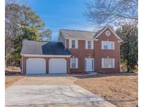 Charming two-story brick home with a two-car garage and well-maintained lawn at 5055 Promenade Sw Dr, Atlanta, GA 30331