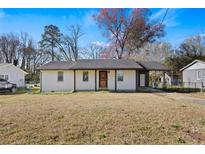 Charming single-story home featuring a covered carport and a well-maintained lawn at 127 Oldenburg Dr, Riverdale, GA 30274