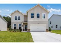 Charming two-story home with a well-manicured lawn and a two-car garage at 209 Groveton Ct, Euharlee, GA 30145