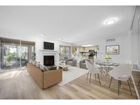 Bright living room with fireplace and tan sofas, adjacent to dining area at 73 Rumson Se Ct, Smyrna, GA 30080
