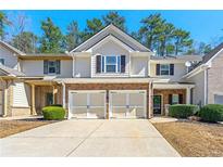 Inviting townhome featuring a two-car garage and charming curb appeal at 1119 Brownstone Dr, Marietta, GA 30008