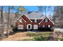 Traditional brick home featuring black shutters, manicured landscaping and a welcoming front entrance at 5679 Brookstone Nw Walk, Acworth, GA 30101