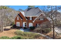 Charming two-story red brick home with black shutters and manicured landscaping at 5679 Brookstone Nw Walk, Acworth, GA 30101