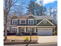 Charming two-story home boasts a well-manicured front yard, two-car garage, and inviting curb appeal at 133 Abbey Pointe Way, Suwanee, GA 30024