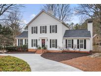 Charming white two-story home with black shutters and a well-manicured front yard at 2828 Saddlebrook Nw Way, Marietta, GA 30064