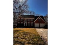 Charming two-story brick home with a well-manicured lawn and a two-car garage at 136 Hunters Ct, Dallas, GA 30157