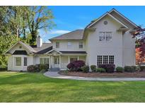 Beautiful home with manicured lawn, lush landscaping, and a classic white facade under a bright blue sky at 17 Blackland Rd, Atlanta, GA 30342