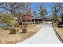 Charming two-story home featuring a well-maintained yard, attached garage, and inviting front porch at 6067 Dana Dr, Norcross, GA 30093