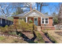 Charming brick home with inviting front porch, landscaped yard, and brick pathway at 902 Edgewood Ne Ave, Atlanta, GA 30307